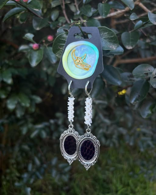 Derp — Snake spine earrings with Cobra skin pendant.