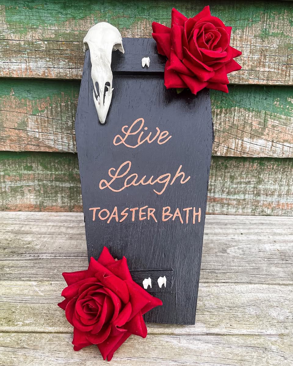 Tub — Pretty Dead coffin sign with a chicken head and monkey teeth.